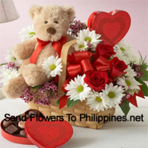 Un bel cesto fatto di rose rosse, gerbere bianche e riempitivi stagionali, una scatola di cioccolatini importati e un tenero orsacchiotto marrone